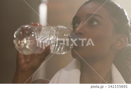 Active, woman and fitness by drinking water in gym for health or energy from training or workout on break. Sporty, Indian female person and hydration for wellness or nutrition for routine with cardio Active, woman and fitness by drinking water in gym for health or energy from training or workout on break. Sporty, Indian female person and hydration for wellness or nutrition for routine with cardio 142155691