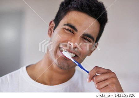 Happy, portrait and man with toothbrush in bathroom for dental hygiene, gum disease and oral care. Health, mouth and face of person brushing teeth for wellness, cleaning and fresh breath in home Happy, portrait and man with toothbrush in bathroom for dental hygiene, gum disease and oral care. Health, mouth and face of person brushing teeth for wellness, cleaning and fresh breath in home 142155820