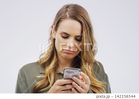 Woman, depression and sad with smartphone for social media post in grey background, technology and emotion. Girl, mental health and stress for marriage, anxiety and browsing on web app or internet Woman, depression and sad with smartphone for social media post in grey background, technology and emotion. Girl, mental health and stress for marriage, anxiety and browsing on web app or internet 142156544