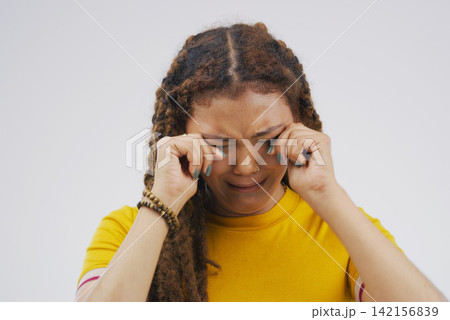 Crying, broken heart and girl in studio with depression, crisis and stress on grey background in pain. Gen z, sorrow and emotional woman frustrated by worry, anxiety and grief with loss and bad news 142156839