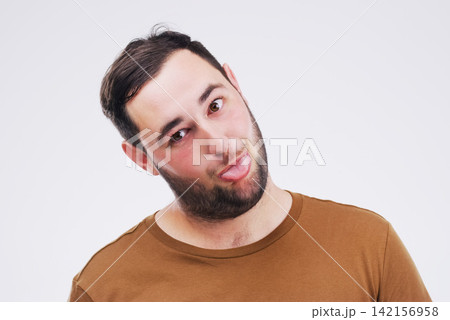 Studio, portrait and man with tongue out, comic and goofy expression with mockup space. Face, male model and comedy or funny with silly reaction, emoji and crazy with backdrop by white background Studio, portrait and man with tongue out, comic and goofy expression with mockup space. Face, male model and comedy or funny with silly reaction, emoji and crazy with backdrop by white background 142156958