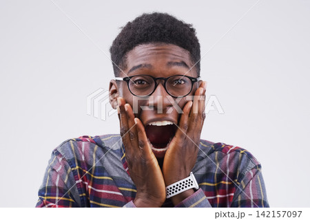 Black man, portrait and shocked on studio background for wow with competition winner, prize giveaway and bonus. African male person, surprise and grey backdrop with omg for success, news and excited 142157097