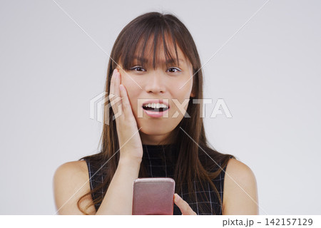 Asian woman, portrait and phone surprise for news in studio, salary increase and lottery success. Female person, shock and offer for bonus on white background, promotion email and discount deal Asian woman, portrait and phone surprise for news in studio, salary increase and lottery success. Female person, shock and offer for bonus on white background, promotion email and discount deal 142157129
