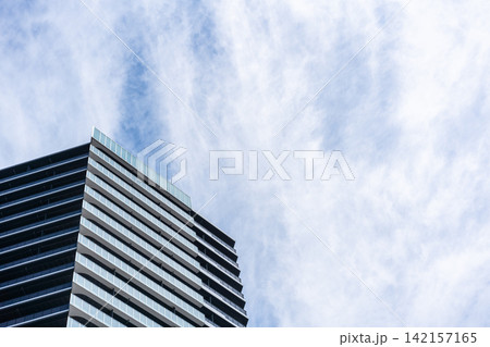 Low angle view of modern residential building with balconies under cloudy sky in Fukuoka, Japan Low angle view of modern residential building with balconies under cloudy sky in Fukuoka, Japan 142157165