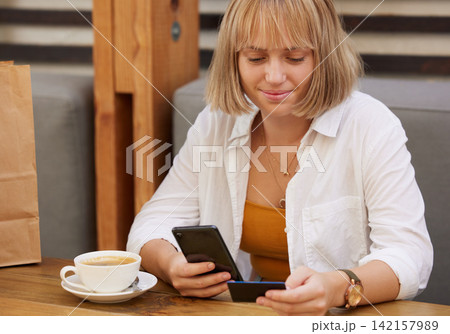 Woman, cellphone and credit card with smile, online shopping and ecommerce for retail sale. Shopper, smartphone and technology for store discount or purchase for internet banking in cafe with coffee 142157989
