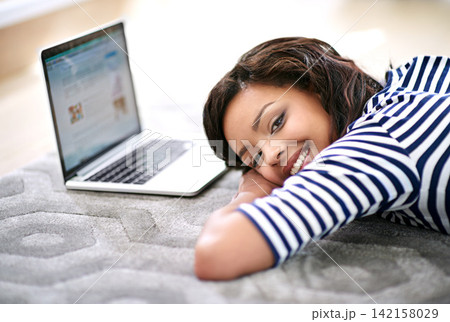 Portrait of girl, laptop screen and lying on floor carpet at home for movie break, relax and rest with smile. Technology, connectivity and computer watch, online videos and female person in house Portrait of girl, laptop screen and lying on floor carpet at home for movie break, relax and rest with smile. Technology, connectivity and computer watch, online videos and female person in house 142158029