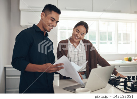 Laptop, happy or couple with budget paperwork, mortgage or banking documents for reading in home. Interracial, woman or man speaking of financial info, investment portfolio or planning loan bills Laptop, happy or couple with budget paperwork, mortgage or banking documents for reading in home. Interracial, woman or man speaking of financial info, investment portfolio or planning loan bills 142158051
