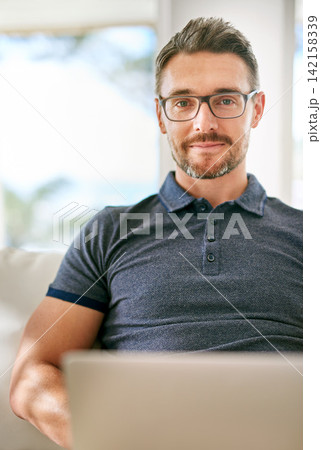 Smile, computer and portrait of man on sofa working on freelance creative project at apartment. Happy, glasses and mature male writer with laptop for research online with blog in living room at home. Smile, computer and portrait of man on sofa working on freelance creative project at apartment. Happy, glasses and mature male writer with laptop for research online with blog in living room at home. 142158339