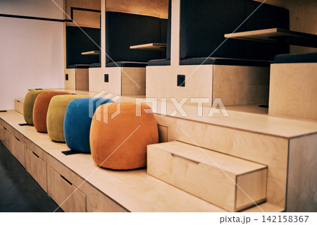 Interior, cubicle and startup office with background, furniture and chair at desk in coworking in workspace. Architecture, workplace and booth with art deco, design and empty room with retro style 142158367