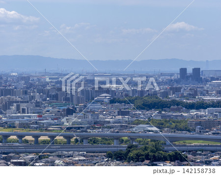 旅客機が上空を飛ぶ街の風景 142158738