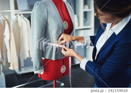 Tailor, fashion and measuring tape on mannequin in boutique workshop with creative seamstress. Luxury, designer and woman fitting fabric for clothes in retail, small business or sewing in warehouse Tailor, fashion and measuring tape on mannequin in boutique workshop with creative seamstress. Luxury, designer and woman fitting fabric for clothes in retail, small business or sewing in warehouse 142159026