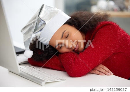 Woman, desktop and Christmas hat with fatigue or sleeping in work from home on table for holiday. Female person, tired and rest in office with technology in house for freelance, copywriting or job 142159027