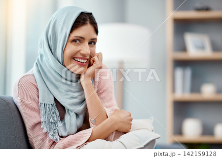 Muslim, woman and portrait in living room for relax, weekend and happiness on sofa in apartment. Hijab, peace and smile in house for morning zen, wellness and lounge indoors for break from work. Muslim, woman and portrait in living room for relax, weekend and happiness on sofa in apartment. Hijab, peace and smile in house for morning zen, wellness and lounge indoors for break from work. 142159128