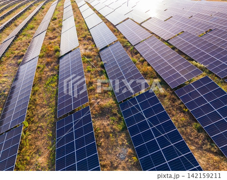 Solar panels cover a large field in a renewable energy farm during daylight hours showcasing the use of clean energy technology Solar panels cover a large field in a renewable energy farm during daylight hours showcasing the use of clean energy technology 142159211
