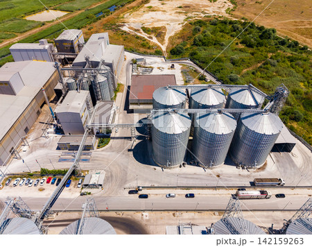 Silos and industrial buildings in a rural area during daytime Silos and industrial buildings in a rural area during daytime 142159263