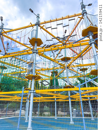 Outdoor climbing park features various rope courses and climbing structures for different skill levels, located in a fun recreational area Outdoor climbing park features various rope courses and climbing structures for different skill levels, located in a fun recreational area 142159411