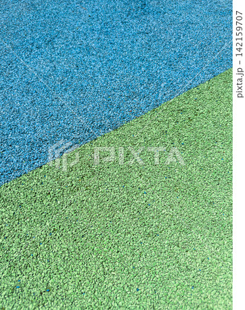 Colorful surface with blue and green areas found in a playground during the day Colorful surface with blue and green areas found in a playground during the day 142159707