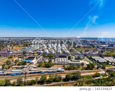 Industry complex with storage tanks and railways seen from above on a clear day Industry complex with storage tanks and railways seen from above on a clear day 142159825
