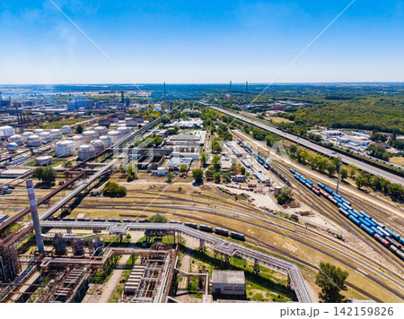 Industrial area with storage tanks and rail yard seen from above in a sunny day Industrial area with storage tanks and rail yard seen from above in a sunny day 142159826
