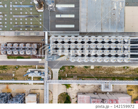 Overview of an industrial facility showing pipes and structures from an aerial view during a clear day Overview of an industrial facility showing pipes and structures from an aerial view during a clear day 142159972