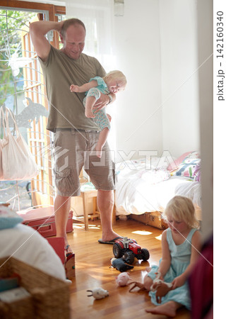 Father, child and smile in home with stress or overwhelmed parenting for hyperactive adhd, siblings or development. Male person, daughters and laughing in bedroom as single dad, toys or housework Father, child and smile in home with stress or overwhelmed parenting for hyperactive adhd, siblings or development. Male person, daughters and laughing in bedroom as single dad, toys or housework 142160340