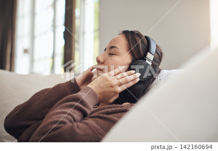 Home, relax and woman with headphones, listening to music and sound with online, audio or radio. Person, apartment and girl with headset or streaming podcast with break or rest with peace or song Home, relax and woman with headphones, listening to music and sound with online, audio or radio. Person, apartment and girl with headset or streaming podcast with break or rest with peace or song 142160694
