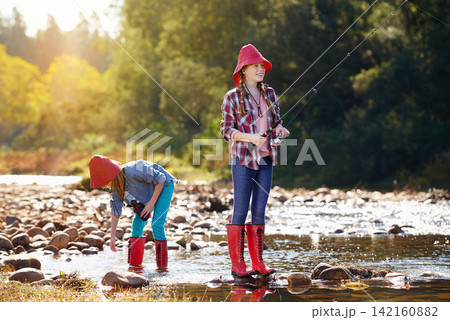 Countryside, children and fishing rod in river on holiday break, vacation or adventure as hobby. Sunshine, girls or siblings and activity to catch fish in water on weekend trip, outdoor and nature Countryside, children and fishing rod in river on holiday break, vacation or adventure as hobby. Sunshine, girls or siblings and activity to catch fish in water on weekend trip, outdoor and nature 142160882