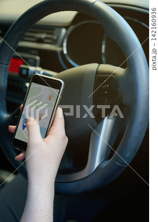 Drive, map and phone with person in car for directions to location, navigation or travel on app. Driving, mobile and route with hand of driver in vehicle for journey, transport or trip to destination Drive, map and phone with person in car for directions to location, navigation or travel on app. Driving, mobile and route with hand of driver in vehicle for journey, transport or trip to destination 142160936