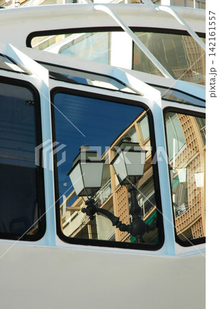 Urban reflection in tourist boat windows 142161557