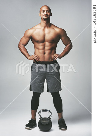 Black man, portrait and kettle bell in studio, shirtless and confidence for workout or training. Male person, athlete and weightlifting for muscle progress on gray background, smile and challenge Black man, portrait and kettle bell in studio, shirtless and confidence for workout or training. Male person, athlete and weightlifting for muscle progress on gray background, smile and challenge 142162591