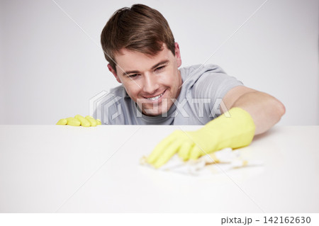 Man, cleaning and home and kitchen counter, happy and wipe with cloth or disinfectant cleaner for germs maintenance. Apartment, housework and health safety, hygiene and glove for bacteria protection Man, cleaning and home and kitchen counter, happy and wipe with cloth or disinfectant cleaner for germs maintenance. Apartment, housework and health safety, hygiene and glove for bacteria protection 142162630