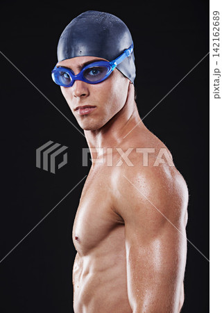 Male, swimmer and face with goggles and cap for fitness, sport or exercise isolated in portrait. Serious, man and athlete with swimming training or cardio practice for competition on black background Male, swimmer and face with goggles and cap for fitness, sport or exercise isolated in portrait. Serious, man and athlete with swimming training or cardio practice for competition on black background 142162689