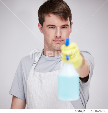 Man, portrait and studio for cleaning with spray bottle, serious and disinfectant liquid cleaner for germs maintenance. Health, safety and hygiene, glove for bacteria protection on white background Man, portrait and studio for cleaning with spray bottle, serious and disinfectant liquid cleaner for germs maintenance. Health, safety and hygiene, glove for bacteria protection on white background 142162697