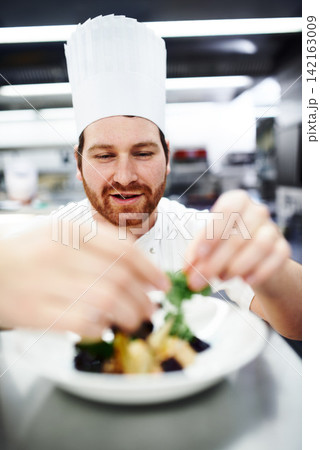 Cooking, chef and man in restaurant kitchen with food plate for fine dining, service or hospitality. Expert, culinary professional or hands preparing meal, lunch or garnish dinner for hotel catering Cooking, chef and man in restaurant kitchen with food plate for fine dining, service or hospitality. Expert, culinary professional or hands preparing meal, lunch or garnish dinner for hotel catering 142163009