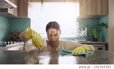Cleaning, woman and kitchen for covid 19 with spray bottle, house chores and safety from bacteria. Female cleaner, cloth and disinfect in home for corona with granite table, ocd and germ protection 142163302