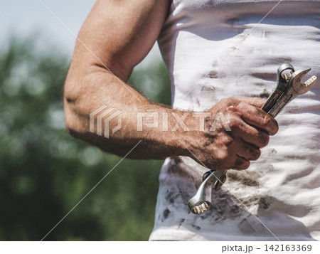 Attractive worker, spanner and dirty t-shirt 142163369