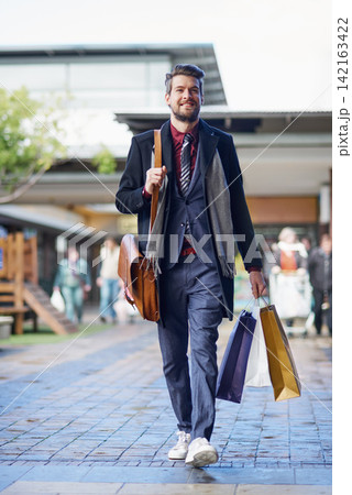 Shopping, man and happy in mall for fashion, retail therapy and satisfaction in market with budget. Male person, smiling and on break from work, business or trading in center for sale, deal or luxury Shopping, man and happy in mall for fashion, retail therapy and satisfaction in market with budget. Male person, smiling and on break from work, business or trading in center for sale, deal or luxury 142163422