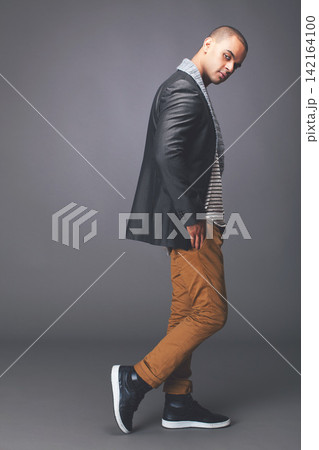 Man, confident and winter outfit in studio for New York fashion week, streetwear and season trends. Male person, trendy and casual apparel isolated by grey background for style on mockup space Man, confident and winter outfit in studio for New York fashion week, streetwear and season trends. Male person, trendy and casual apparel isolated by grey background for style on mockup space 142164100
