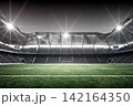 Football Stadium Glowing Under Stadium Lights 142164350