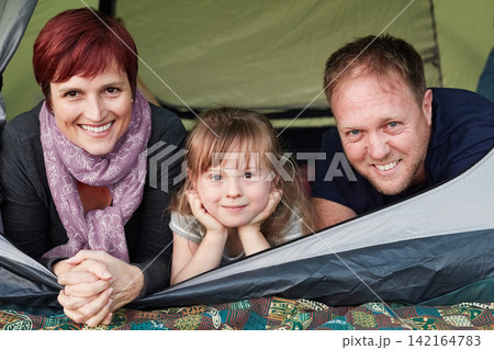 Family, people and portrait for camping in tent, outdoors and adventure for holiday in wilderness. Vacation, travel and bonding in summer with mother and father, daughter and happy for nature outside Family, people and portrait for camping in tent, outdoors and adventure for holiday in wilderness. Vacation, travel and bonding in summer with mother and father, daughter and happy for nature outside 142164783