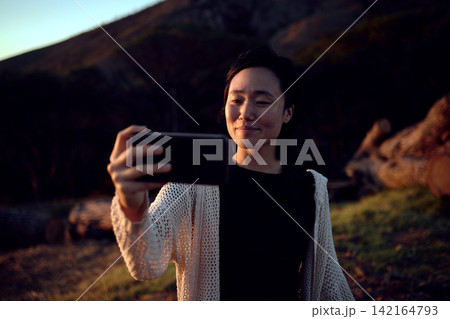 Hiking, selfie and Asian woman on mountain with smile, nature and relax on holiday adventure. Digital photography, outdoor trekking and happy girl with natural view, travel and memory on vacation. Hiking, selfie and Asian woman on mountain with smile, nature and relax on holiday adventure. Digital photography, outdoor trekking and happy girl with natural view, travel and memory on vacation. 142164793