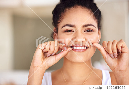 Happy, dental floss and portrait of woman with cleaning teeth for morning mouth routine in bathroom. Smile, dentistry and face of female person with oral care thread for hygiene treatment at home. 142165023
