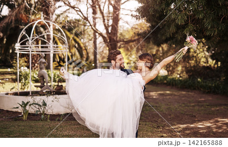 Happy, married and couple for wedding to carry wife in garden for celebration, ceremony and commitment in summer. Smile, woman and man for relationship, romance and love with special tradition 142165888