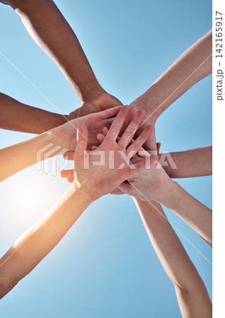 People, team and hands together below for unity, collaboration or synergy on a blue sky background. Closeup or low angle of group or community piling or stacking in solidarity for join or mission People, team and hands together below for unity, collaboration or synergy on a blue sky background. Closeup or low angle of group or community piling or stacking in solidarity for join or mission 142165917