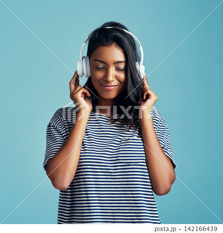 Woman, studio and headphones with happy music, listening and streaming podcast for calm with gen z. Radio audio, technology for song entertainment with sound, Indian female person on background 142166439