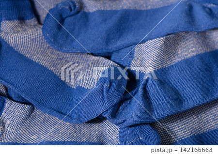 Pile of blue and white striped socks background Pile of blue and white striped socks background 142166668
