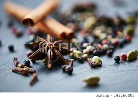 Closeup of whole spices, mix of ingredients and cooking for food, fragrance and flavor with culinary background. Stick cinnamon, star anise and peppercorn for catering, seasoning collection and aroma Closeup of whole spices, mix of ingredients and cooking for food, fragrance and flavor with culinary background. Stick cinnamon, star anise and peppercorn for catering, seasoning collection and aroma 142166805