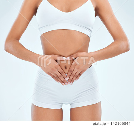 Health, stomach and woman for gut, digestion and nutrition on white background. Fruit, diet and detox for weight loss and benefits and colon wellness for vitamins and food in studio with love Health, stomach and woman for gut, digestion and nutrition on white background. Fruit, diet and detox for weight loss and benefits and colon wellness for vitamins and food in studio with love 142166844