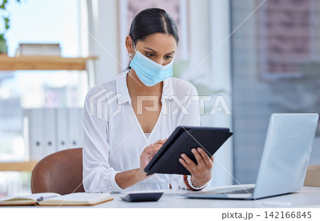 Tablet, modern office and woman with face mask for virus protection, compliance and health or safety in global pandemic for corporate career. Business person, tech and PPE at workspace from disease Tablet, modern office and woman with face mask for virus protection, compliance and health or safety in global pandemic for corporate career. Business person, tech and PPE at workspace from disease 142166845