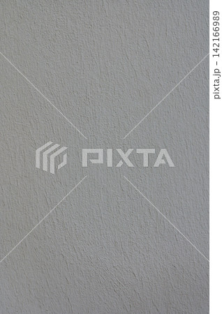 Textured plaster wall exhibiting subtle color variations under natural light, creating a soft and calming atmosphere 142166989